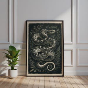 May include: A framed wall art print featuring a detailed black and white illustration of a coiled snake surrounded by intricate botanical foliage. The artwork is presented in a dark rectangular frame, showcasing a high-contrast design with textured scales.