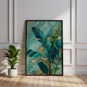May include: A framed art print with a botanical theme. The artwork displays large, stylized teal and gold leaves against a swirling teal background. The print is set in a black frame and leans against a white wall. A potted plant sits to the left.