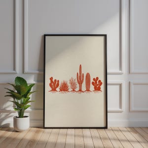 May include: A framed vertical wall art print featuring a row of six distinct terracotta-coloured cactus illustrations centred on a light cream-coloured background. The artwork is enclosed in a thin black frame, showcasing a variety of desert plant shapes.