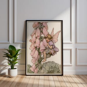 May include: A framed wall art print featuring a vintage-style illustration of a small fairy with delicate wings sitting on a tall stalk of pale pink foxglove flowers. The artwork uses soft pastel tones and detailed line work to depict the fairy.