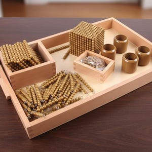 May include: A wooden tray with Montessori educational materials. The tray contains golden beads in various forms: loose, in strings, and in a cube. Also included are small wooden cylinders and a small box with a clear plastic bag of small objects.