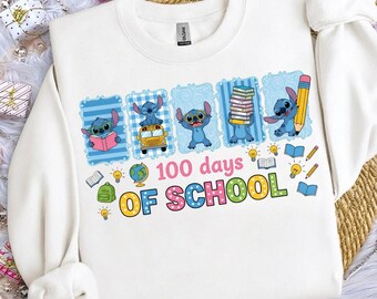 May include: White sweatshirt featuring the character Stitch from Lilo & Stitch celebrating "100 days of school." The design includes Stitch with books, a school bus, and a pencil. The text "100 days of school" is in colorful letters.