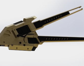 May include: A mechanical device featuring a textured gold-colored body with black accents. The object has two long, parallel, pointed arms extending from a central housing, which includes visible screws, joints, and geometric cutouts.