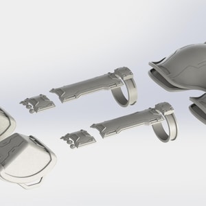May include: A collection of gray, futuristic-looking armor pieces, including shoulder pads, forearm guards, and smaller components. The design features geometric shapes and a metallic appearance, suggesting a sci-fi or cosplay theme.