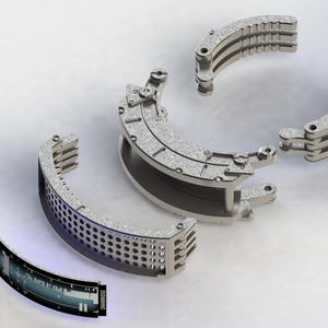 May include: A detailed, technical illustration of a silver-colored, segmented mechanical device. The design features curved, layered components with visible screws and hinges. A separate, curved screen displays data, with the word "DRAWBRIDGE" visible.