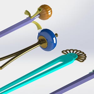 May include: A collection of decorative hair accessories, including hair sticks and pins. The designs feature various shapes and colors, such as a blue and gold hair stick, a teal hair pin with a fan-shaped accent, and a purple hair stick with a rose.