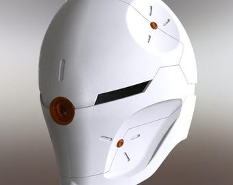 May include: A white futuristic helmet with orange circular accents and angular design elements. The helmet has a smooth, matte finish and a visor-like opening. The design suggests a sci-fi or cosplay theme.