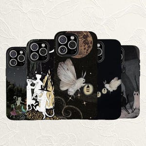 May include: Five smartphone cases featuring dark, illustrative designs. The cases display white cats wearing witch hats around a campfire, a large moth holding a glowing lantern against a moonlit sky, and small ghosts in a dark forest setting.
