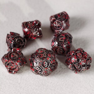 May include: Set of eight metallic dice with a steampunk design. The dice are silver with red accents and feature gears and numbers. Ideal for tabletop gaming.