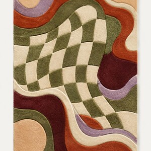 May include: A rectangular area rug featuring a tufted texture with a central warped checkerboard pattern in olive green and cream. The design includes flowing, organic shapes in shades of terracotta, deep burgundy, lavender, and soft peach.