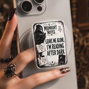 May include: A light gray smartphone with a rectangular phone grip featuring a black and white illustration of a plague doctor reading a book. The text reads: Midnight Notes, Leave me alone, I'm reading after dark, and other small notes.