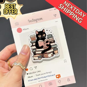 May include: A sticker featuring a black cat reading a book, surrounded by stacks of books and coffee cups. The sticker is designed to look like an Instagram post, with the text "Album" and "520.1314 Likes". The words "BEST OFFER" and "NEXTDAY SHIPPING" are also visible.