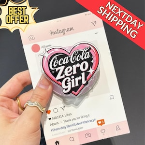 May include: A pink and white Coca-Cola Zero Girl heart-shaped sticker on a pink Instagram-themed background. The sticker has a black outline and star accents. The image also includes the text "BEST OFFER" and "NEXTDAY SHIPPING".