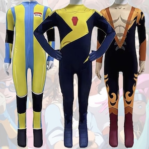 May include: Three full-body superhero costumes on mannequins. The first is yellow and blue with a zipper, the second is navy blue and yellow with a red emblem, and the third is black and orange with flame-like designs.
