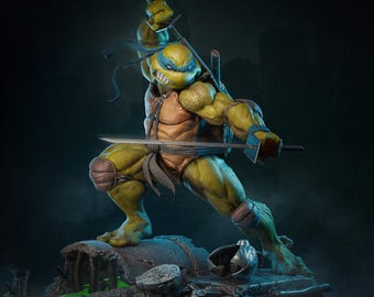May include: A detailed statue of Leonardo, a Teenage Mutant Ninja Turtle, in a dynamic fighting pose. The figure is predominantly green and tan, with a blue mask and wielding two katanas. The statue is on a detailed base with a dark, smoky background.