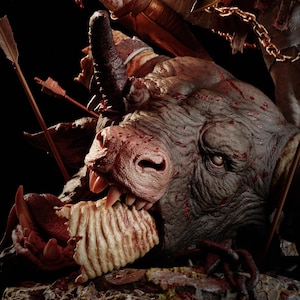 May include: A detailed sculpture of a dark grey, horned beast head with textured skin, sharp teeth, and blood-like red markings. Several thin arrows are embedded into the creature's head and neck, and a piece of white, ribbed material is held in its mouth.