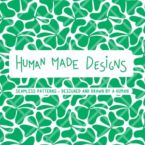 May include: A seamless pattern design featuring green abstract floral shapes on a white background. The image includes the text "HUMAN MADE DESIGNS" and "SEAMLESS PATTERNS - DESIGNED AND DRAWN BY A HUMAN" in a white rectangular box.
