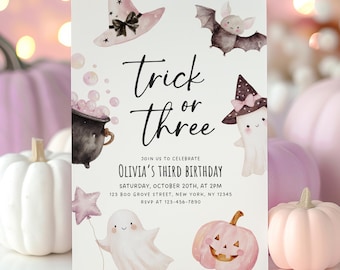 May include: A white birthday invitation card featuring watercolor illustrations of a pink witch hat, a bat, a black cauldron with pink bubbles, a ghost wearing a hat, a ghost holding a star balloon, and a pink jack-o'-lantern with text Trick or three.