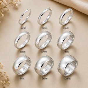 May include: A collection of nine polished silver rings arranged in a grid, each stamped with 925. The rings are labeled by width from 2mm to 10mm, showing a gradual increase in band thickness across the rows from left to right and top to bottom.
