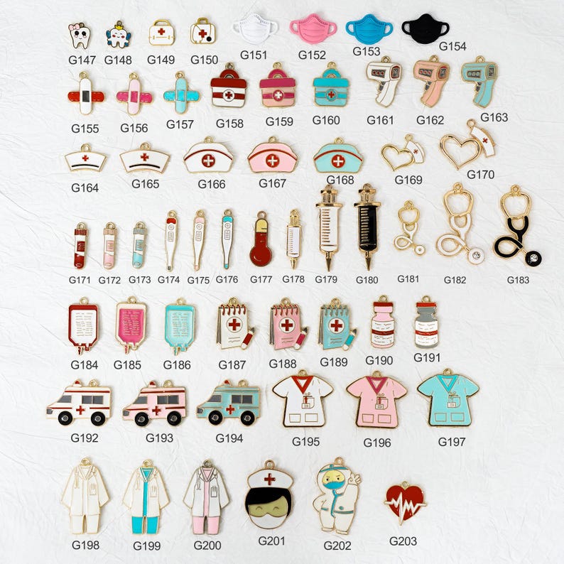 May include: A collection of gold-colored medical-themed charms, including stethoscopes, syringes, thermometers, and medical crosses. The charms are in various shapes and sizes, with enamel details in red, pink, blue, and white.