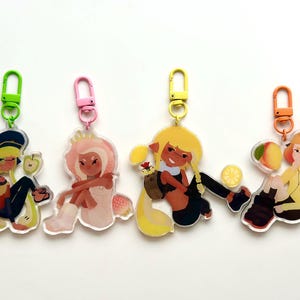 May include: Four acrylic keychains featuring cartoon characters with fruit themes. Each keychain has a different color clasp: green, pink, yellow, and orange. The characters are in various poses, with details like hats, clothing, and fruit accents.