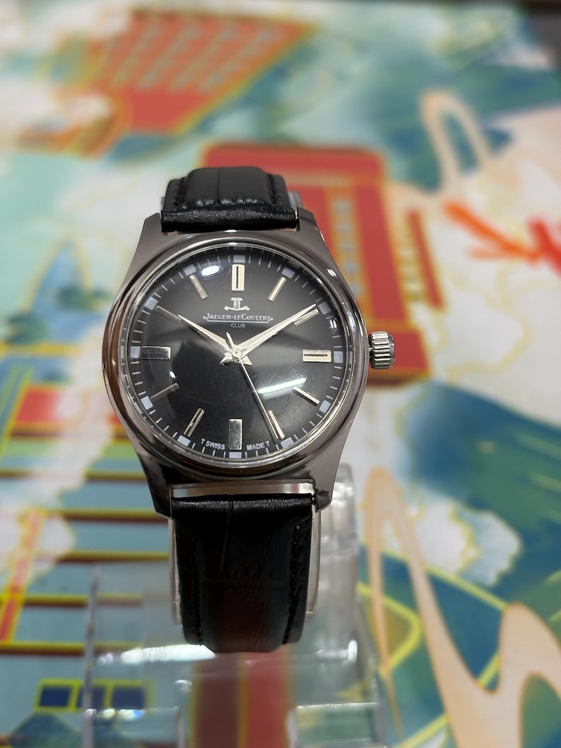 Ideal for watch collectors, vintage enthusiasts, and lovers of luxury timepieces, this Jaeger-LeCoultre Club watch stands out as a rare and collectible piece. Perfect as a gift for him, anniversary present, birthday gift, or festive season gift idea. This retro wristwatch pairs well with both formal and casual outfits, adding a touch of sophistication to any look. Keywords: vintage Jaeger-LeCoultre watch, black dial watch, manual wind watch, Swiss luxury watch, classic dress watch, collectible