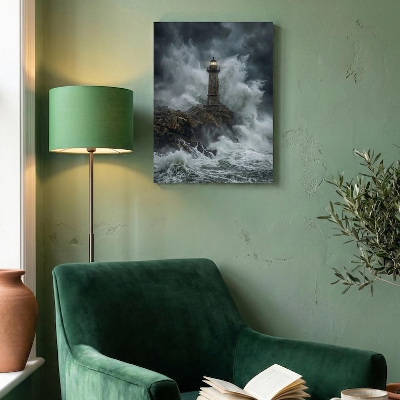 May include: A canvas print depicts a lighthouse on a rocky coast, battered by a stormy sea. The lighthouse is gray, with a bright light at the top. The waves are white and foamy, and the sky is dark and cloudy. The print is displayed on a green wall.