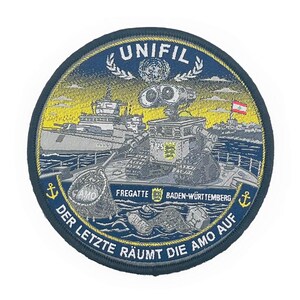 May include: A circular embroidered patch featuring the robot Wall-E on a ship deck, with the text UNIFIL, FREGATTE BADEN-WÜRTTEMBERG, and DER LETZTE RÄUMT DIE AMO AUF. The design includes a naval vessel, a Lebanese flag, and anchors in blue and yellow.