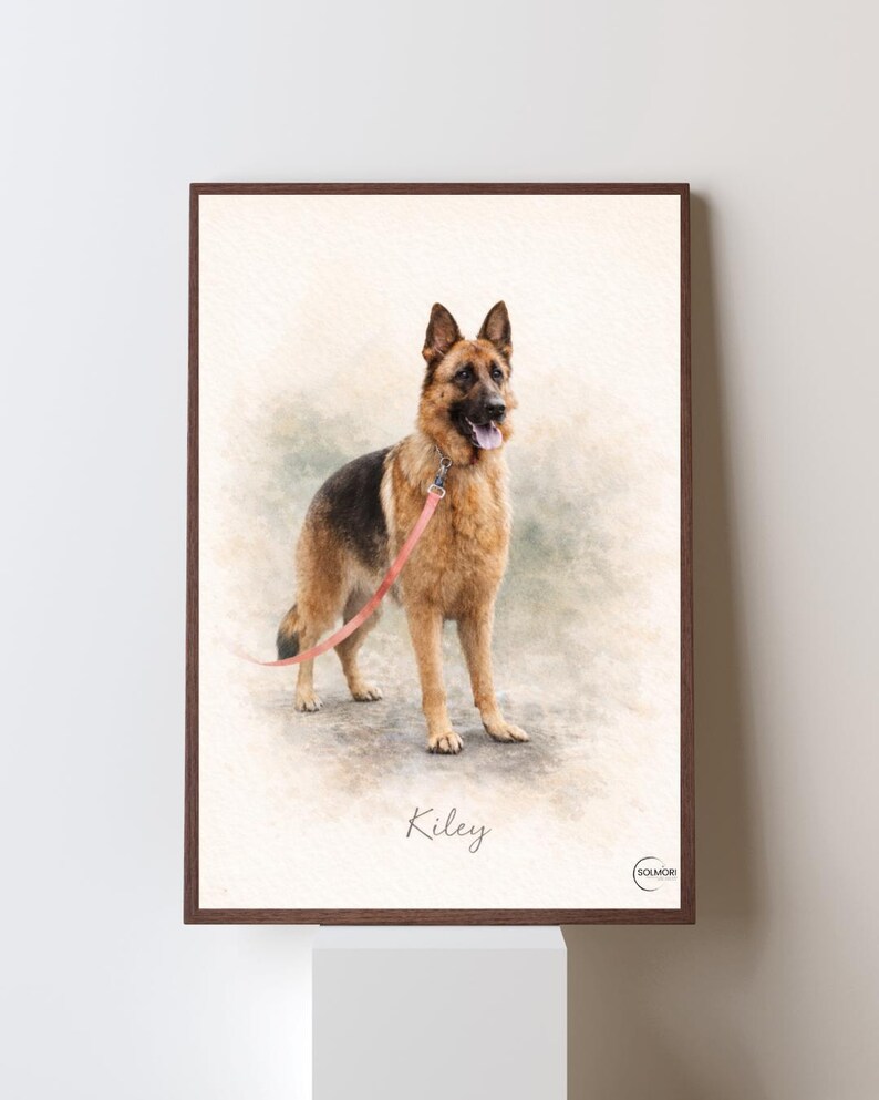 May include: Watercolor-style portrait of a German Shepherd dog with a pink leash, set in a brown framed print. The dog is tan and black, with its tongue out. The name "Kiley" is written below the dog.