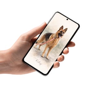 May include: A smartphone displays a watercolor-style image of a German Shepherd dog with a pink leash. The dog is tan and black, with its mouth open. The name "Kiley" is written below the dog.