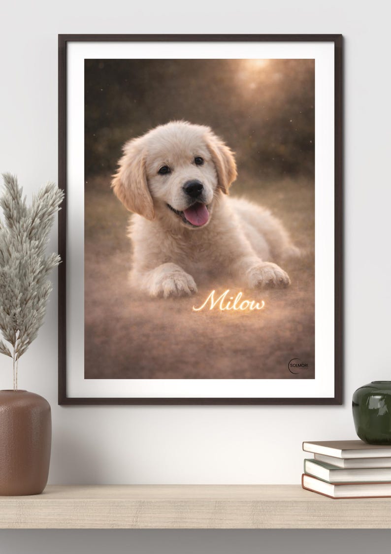 May include: A framed print featuring a Golden Retriever puppy lying down, with a soft, blurred background. The puppy has light-colored fur and is looking at the viewer with its tongue out. The name "Milow" is written in a glowing script.