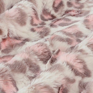 May include: A soft, plush throw blanket with a pink and brown leopard print pattern.