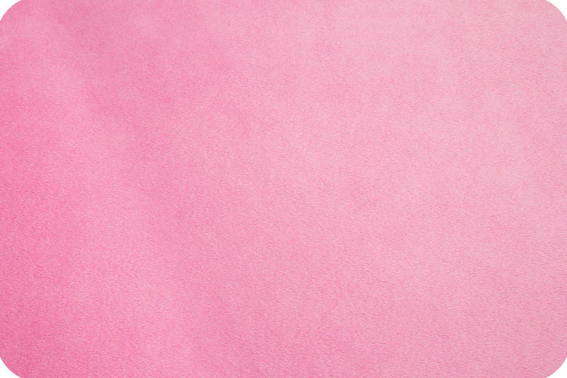 Puede incluir: Una muestra de tela rosa s&oacute;lida con una superficie ligeramente texturizada.