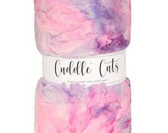 May include: A pink and purple tie-dye minky fabric precut, rolled up and labeled "Cuddle Cuts" with the text "2 Yard Cuddle minky fabric precut".