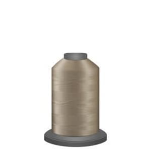 May include: A spool of beige thread for sewing.