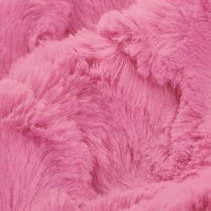 May include: Close-up of a soft, pink faux fur fabric. The fabric has a fluffy texture and a subtle sheen.