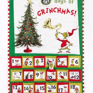 May include: A fabric Christmas advent calendar with a green and white background. The calendar features a decorated Christmas tree, the Grinch, and the text "25 days of GRINCHMAS!". Each day has a numbered pocket with a Grinch-themed image.