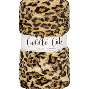 May include: A roll of 2 yards of Cuddle Cuts minky fabric in a leopard print pattern. The fabric is a soft, plush material with a brown and tan color scheme.
