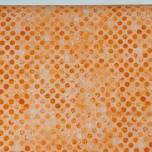 May include: A fabric featuring a repeating pattern of solid orange circles arranged in a grid on a lighter orange background. The circles have a textured, mottled appearance, and the overall design creates a consistent, uniform polka dot motif.