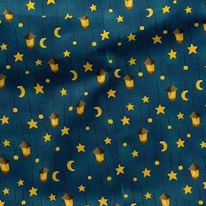 May include: A dark teal fabric with a repeating pattern of yellow stars, crescent moons, and lanterns. The lanterns have brown roofs and yellow glowing lights. The design is reminiscent of a starry night sky.