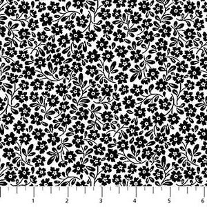 May include: White fabric with a black floral pattern. The pattern features small, simple flowers and leaves.