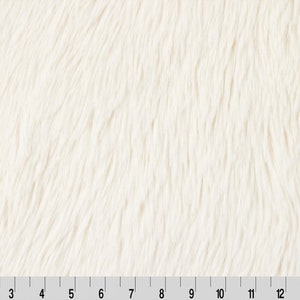 May include: White faux fur fabric with a soft, fluffy texture. The fabric has a subtle, wavy pattern.