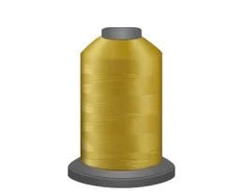 May include: A spool of gold thread for sewing or embroidery.