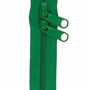 May include: A green zipper with two pull tabs. The zipper is closed and the pull tabs are in the up position.