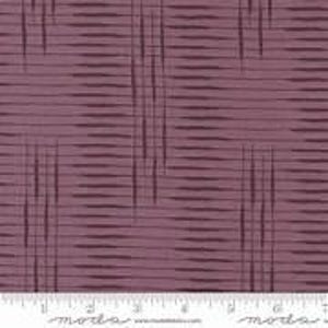 May include: Close-up of a fabric with a mauve background and a dark purple linear pattern. The pattern consists of horizontal lines with vertical lines intersecting them. A ruler with inch measurements is at the bottom.