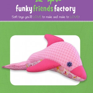 May include: A pink and white fabric dolphin soft toy with a pink polka dot pattern. The toy is 17 inches long and is called "Dizzy Dolphin".