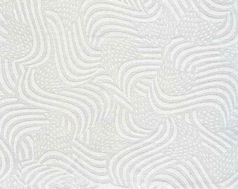 May include: A textured, off-white fabric with a repeating pattern of curved lines and small star-like shapes. The design creates a flowing, wave-like effect across the surface. The fabric appears to be a neutral color, suitable for various applications.