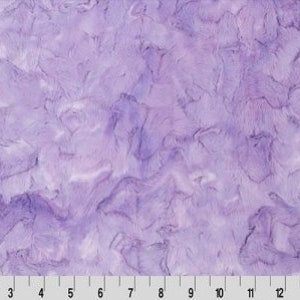 May include: Purple faux fur fabric with a marbled pattern. The fabric has a soft, plush texture.