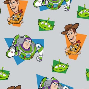 May include: A repeating pattern featuring characters from the animated film Toy Story. The design includes images of Woody, Buzz Lightyear, and the Little Green Men aliens, set against a light grey background with colourful geometric shapes.