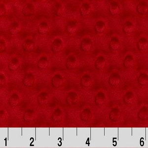 May include: Red minky fabric with a textured dot pattern. The fabric is measured in inches.